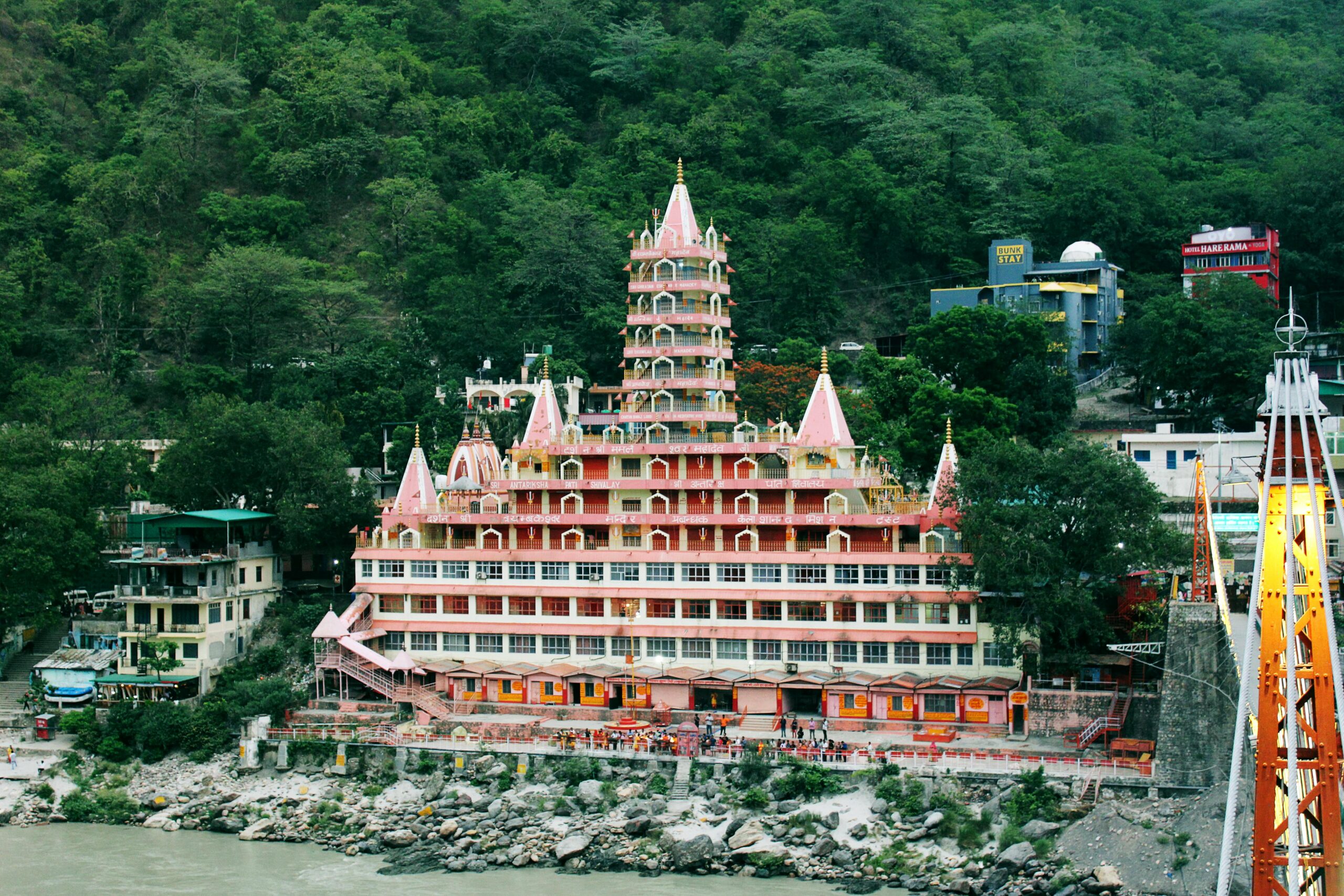 Stunning view of Tera Manzil Temple against lush hills in Rishikesh, India.
